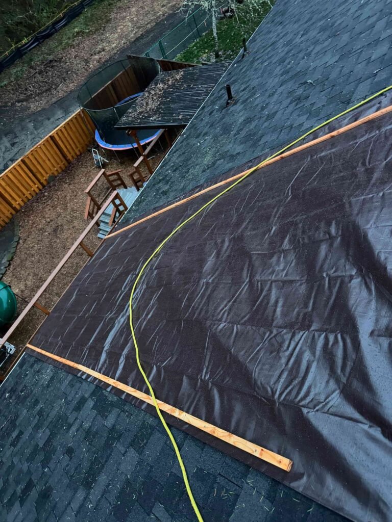 Emergency roof tarping after fallen tree damage